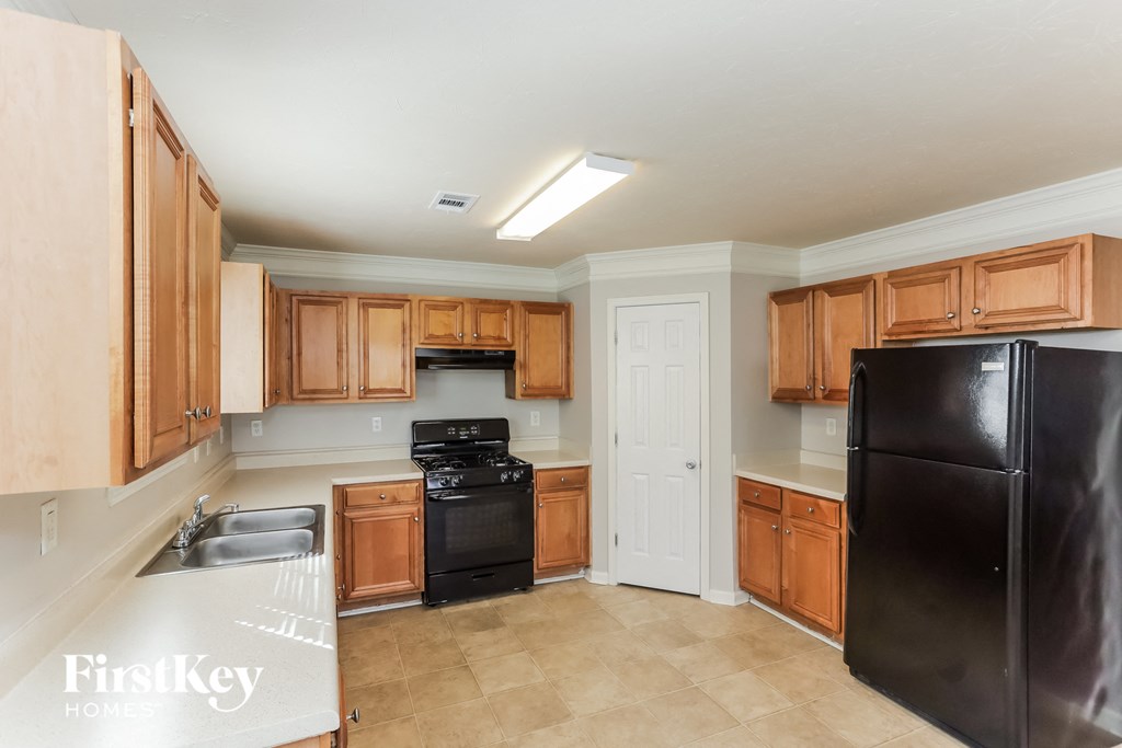 a kitchen with black appliances and wooden cabinets