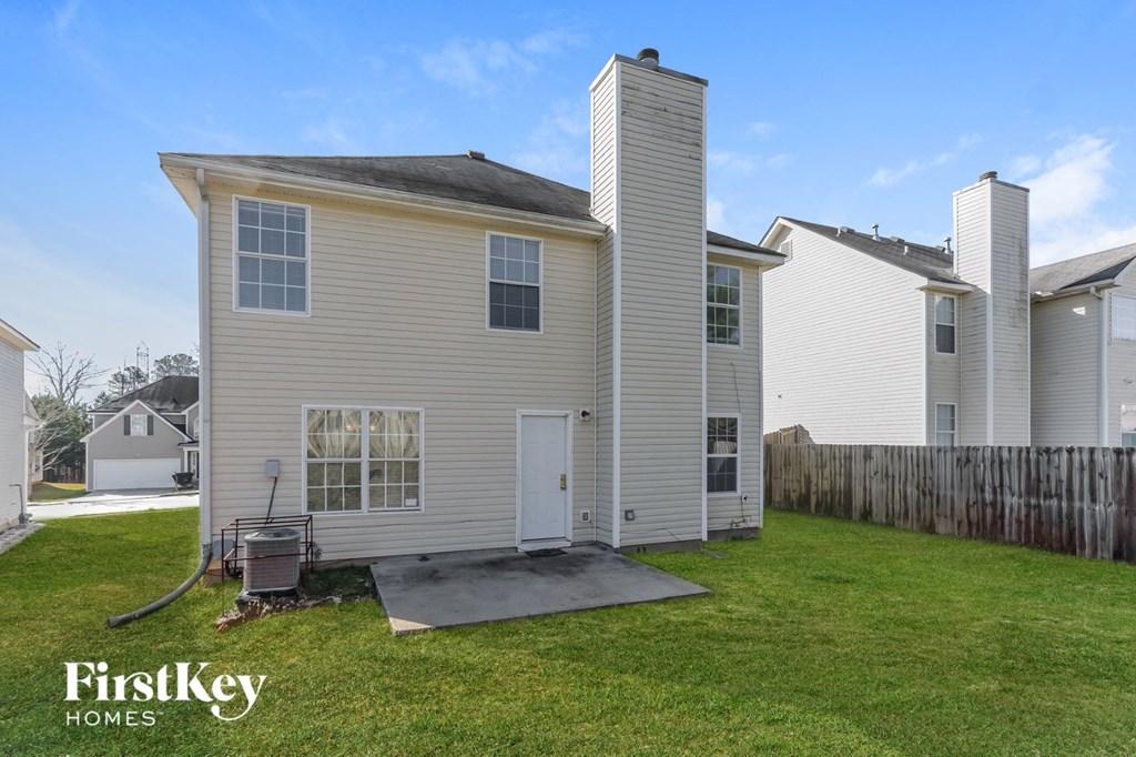 the back of a house with two chimneys on top of it