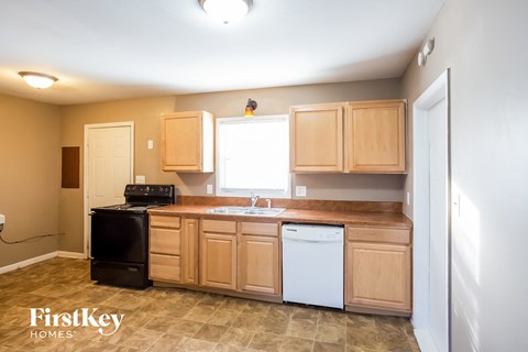 a kitchen with wooden cabinets and a white dishwasher