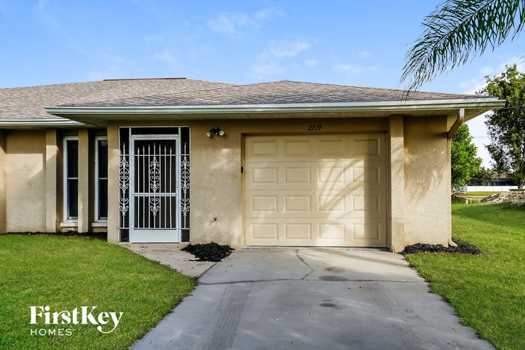 a beige house with a white garage door