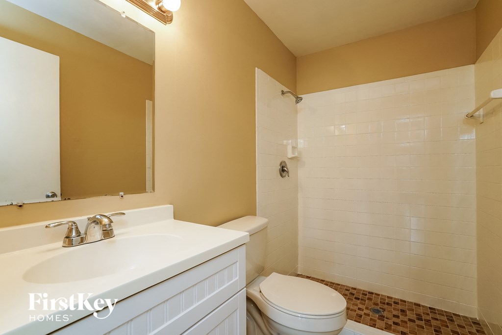 a bathroom with a sink toilet and a shower