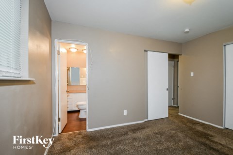 a living room with a toilet and a door to a bathroom