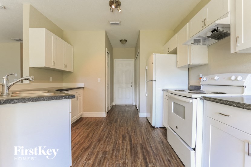 A kitchen with a FirstKey logo on the island.