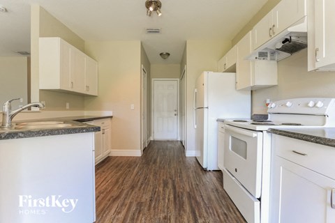 A kitchen with a FirstKey logo on the island.