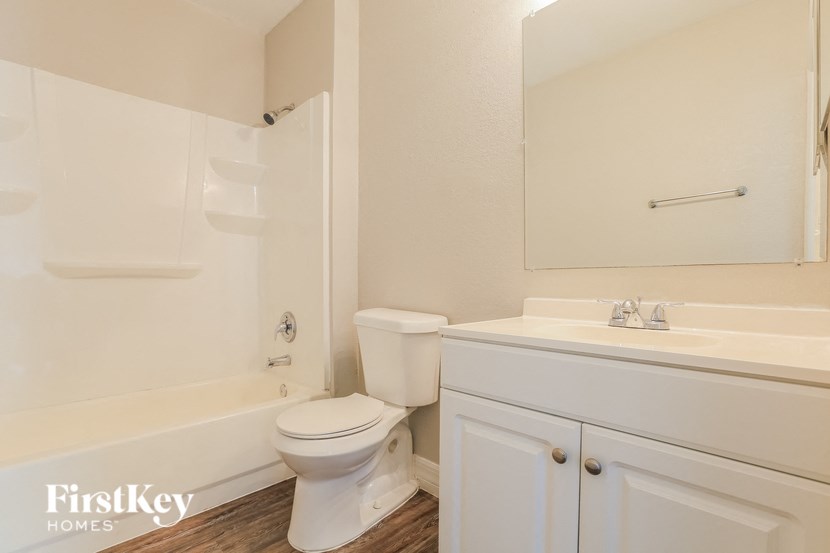 A white toilet and sink in a bathroom.