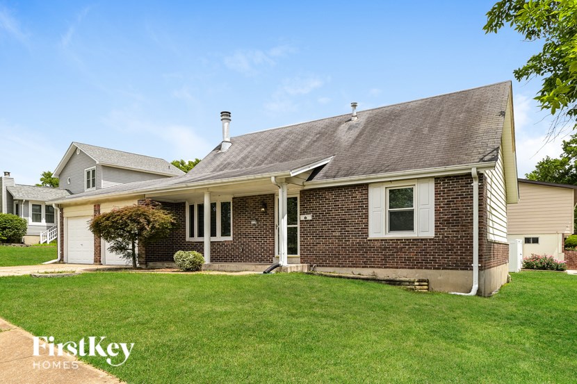 A house with a brick facade and a white door.