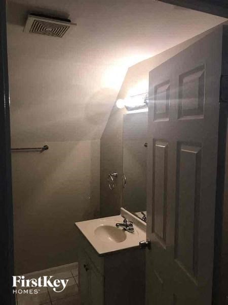 A small bathroom with a sink and a mirror.