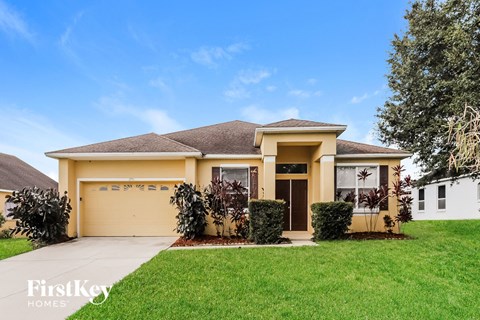 A house with a brown roof and a white garage door.