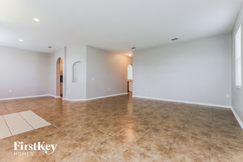 A spacious room with a tiled floor and a FirstKey Homes logo.