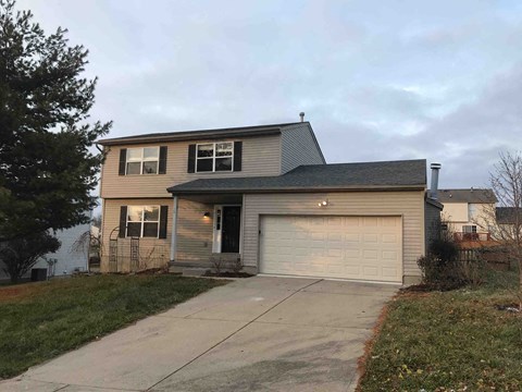 a house with a driveway and a garage door
