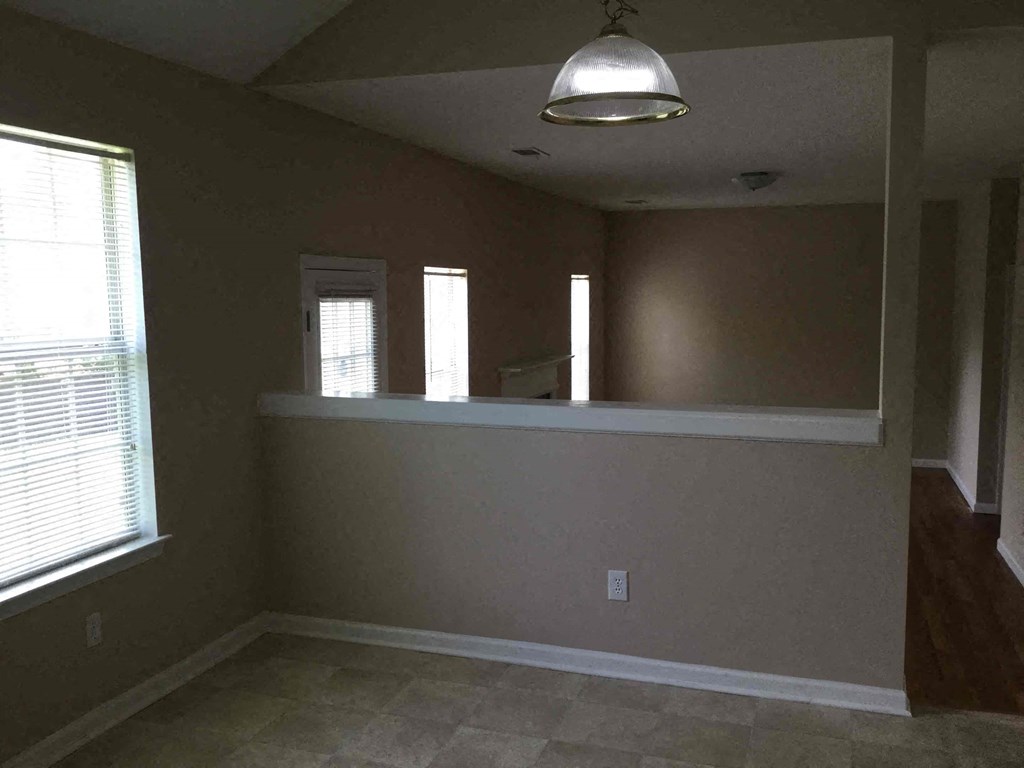 an empty room in a house with a large window