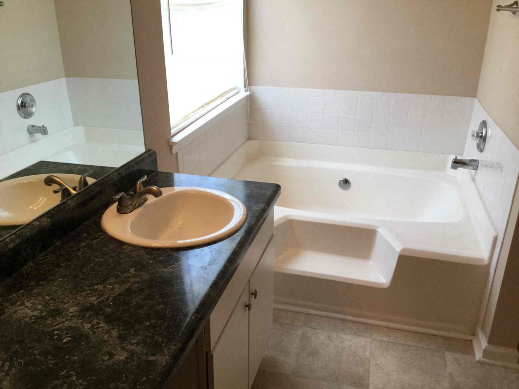 a bathroom with a sink and a bath tub