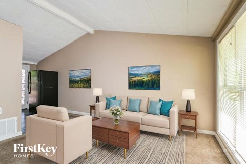 A living room with a couch, chair, and coffee table.