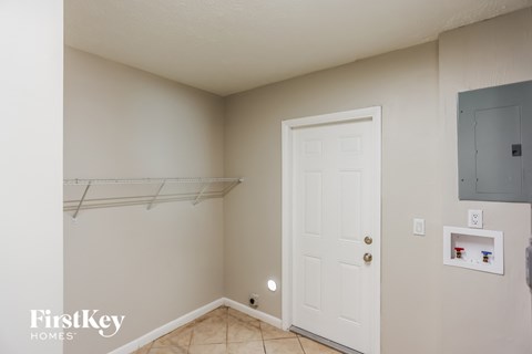 a bedroom with a closet and a white door and a hanging rack on the wall