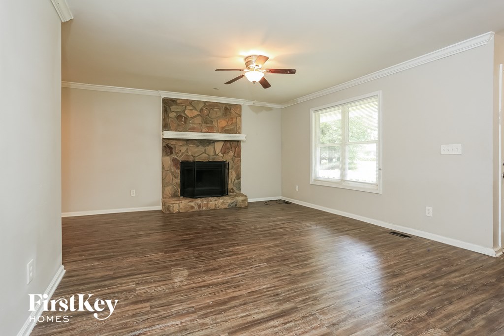 the living room of an empty house with a fireplace