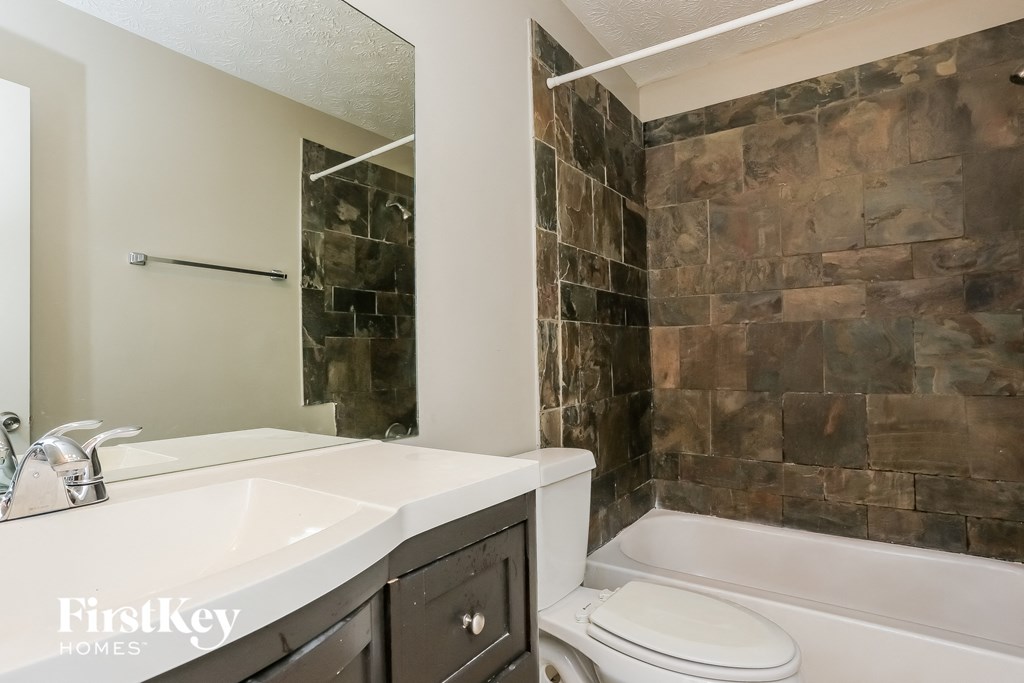 a bathroom with a sink and a toilet and a tub