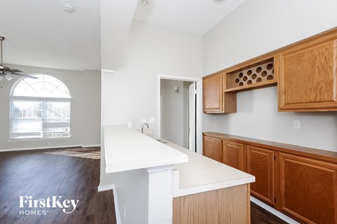 A kitchen with wooden cabinets and a white countertop.