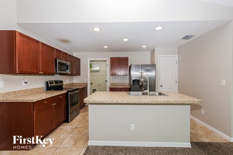A kitchen with brown cabinets and a countertop.