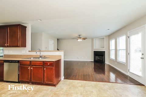 A kitchen with wooden cabinets and a black oven.