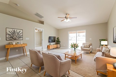 A living room with a brown sofa and a wooden table.