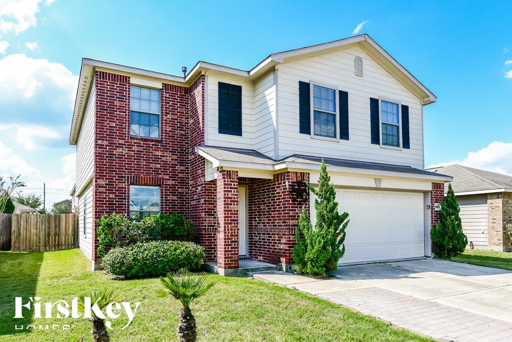 a brick and with a white garage door