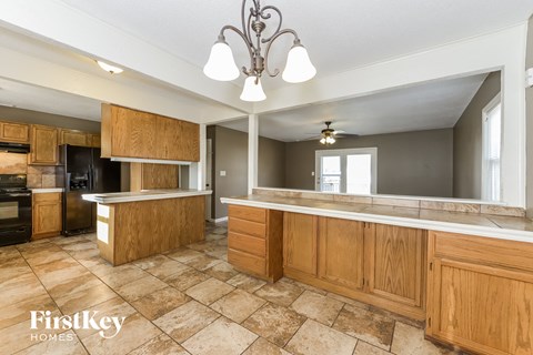 a kitchen with wooden cabinets and a large counter top