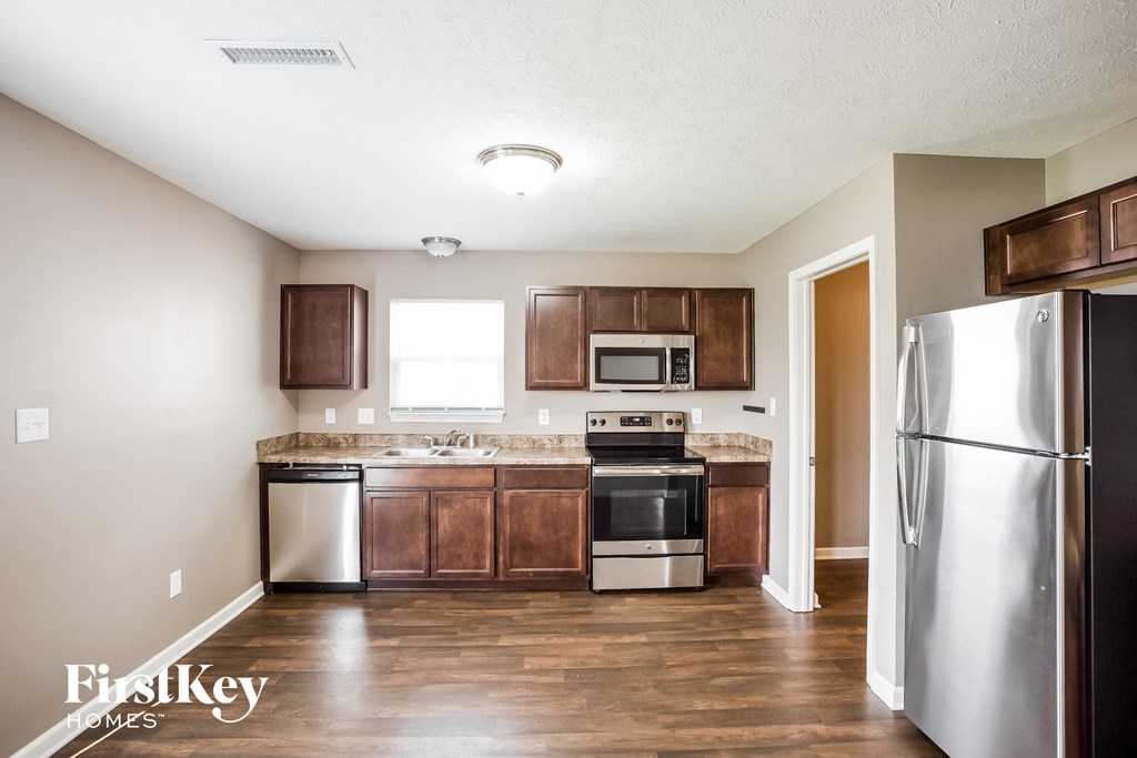 a kitchen with stainless steel appliances and wooden cabinets