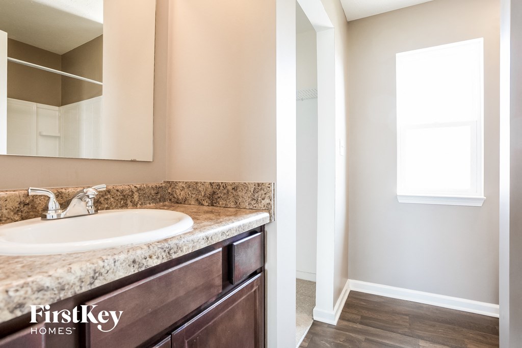 an empty bathroom with a sink and a mirror