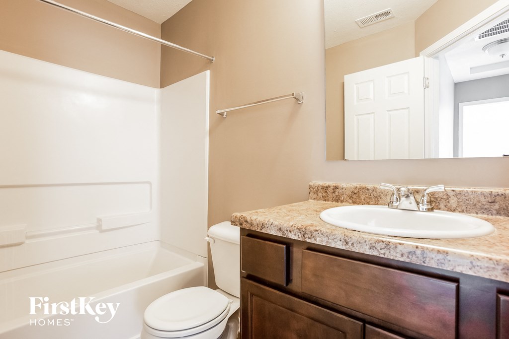 a bathroom with a sink and a toilet and a shower