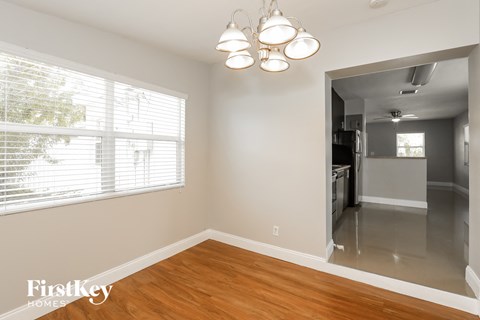 a living room with a wood floor and a large window