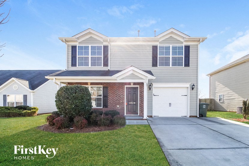 A house with a grey roof and a brown garage door.