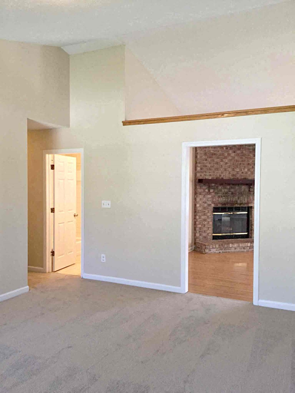 A room with a fireplace and a door.