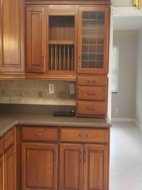 a kitchen with wooden cabinets and a counter top