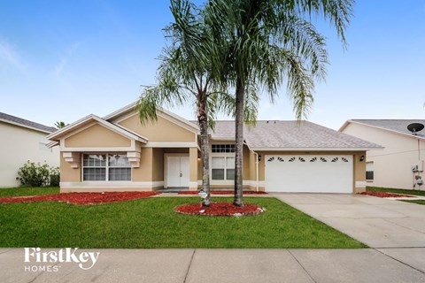A house with a palm tree in front of it.