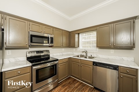 A kitchen with wooden cabinets and stainless steel appliances.