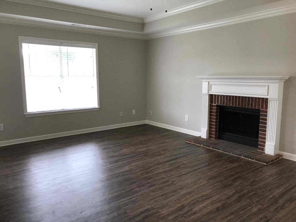 A room with a fireplace and a window.