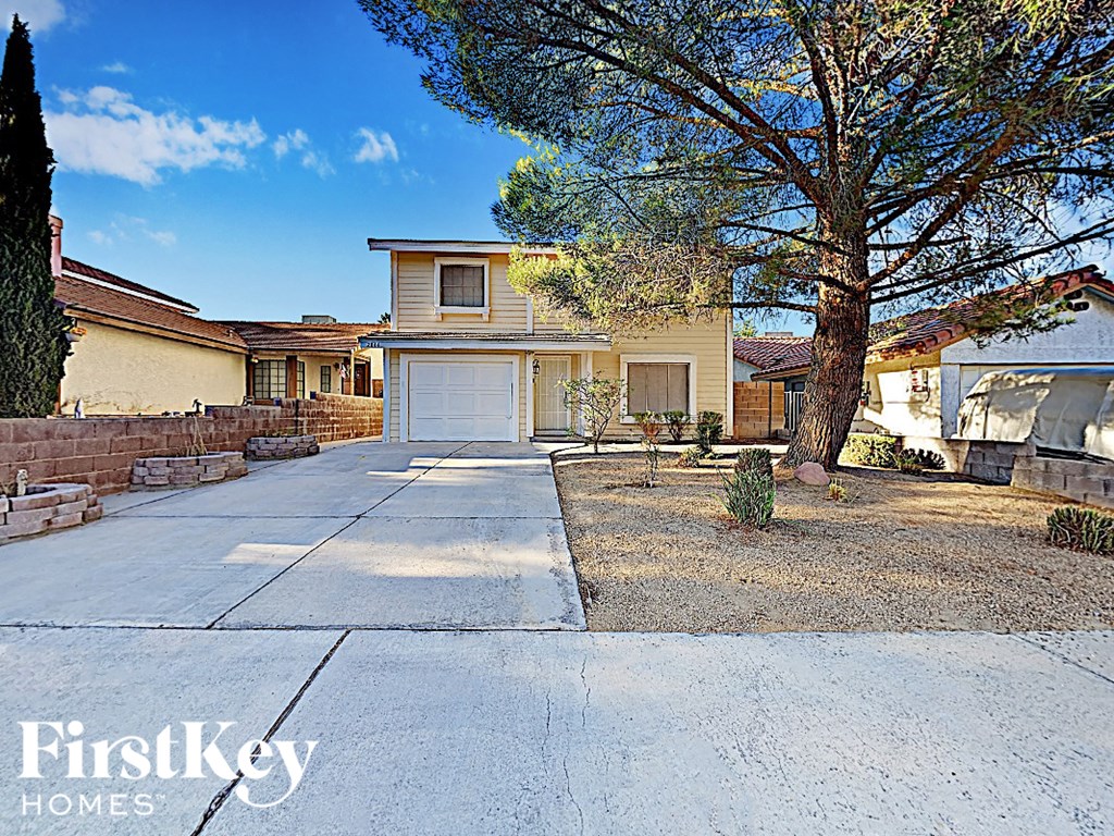 a driveway in front of a house with a white garage door