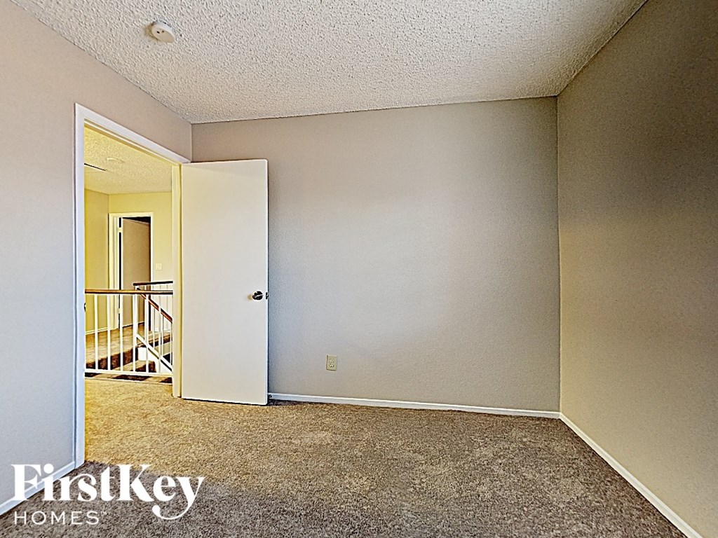 the living room of an empty house with an open door