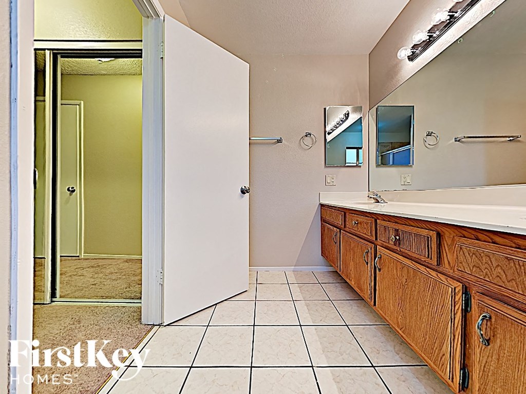 a bathroom with a tub and a sink and a mirror