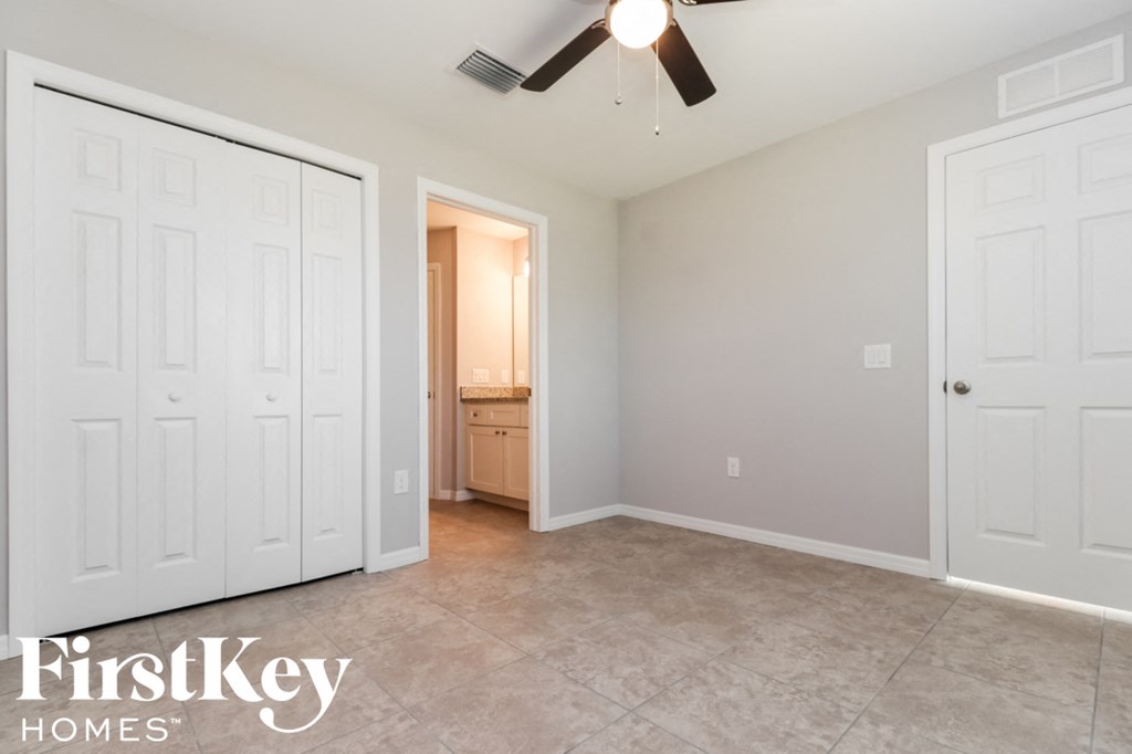 a bedroom with two closets and a door to a bathroom