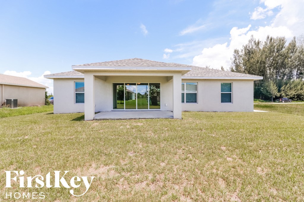 a small white house with a lawn in front of it