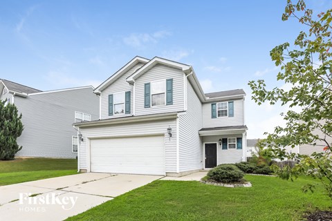 a white house with white siding and a green lawn