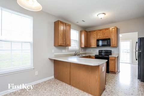 a kitchen with wooden cabinets and a white counter top