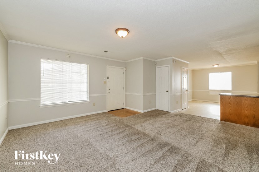 the living room and dining room of an empty house