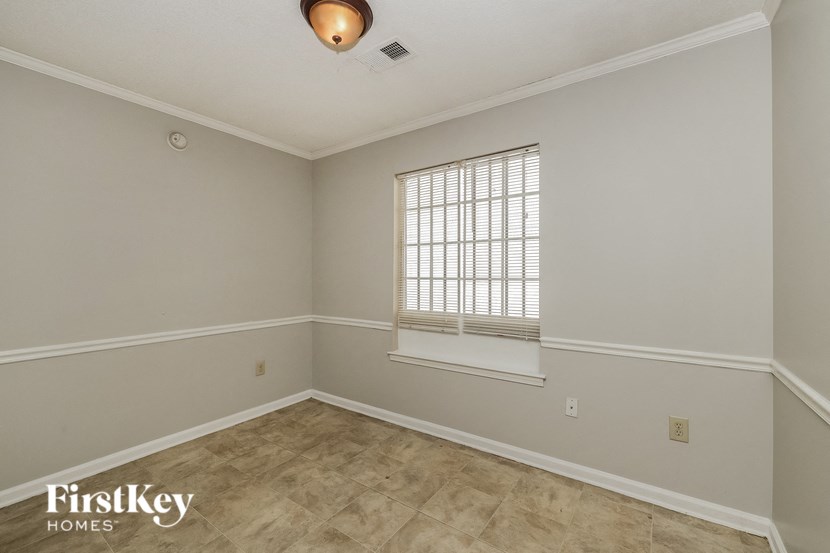 the living room of an empty home with a window and a window sill