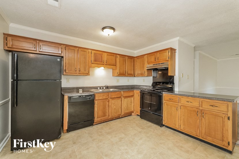 a kitchen with wooden cabinets and stainless steel appliances