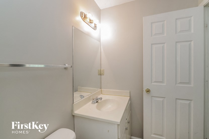 a small bathroom with a sink and a mirror and a shower