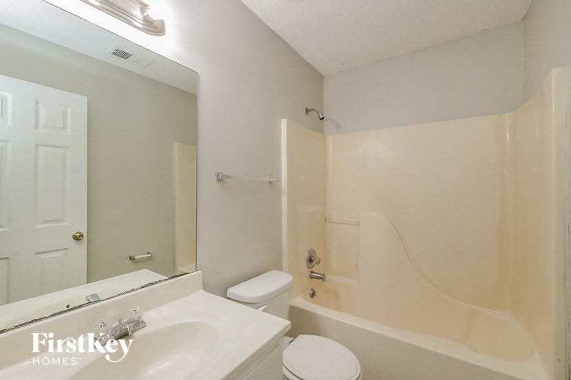 a bathroom with a sink toilet and a bath tub