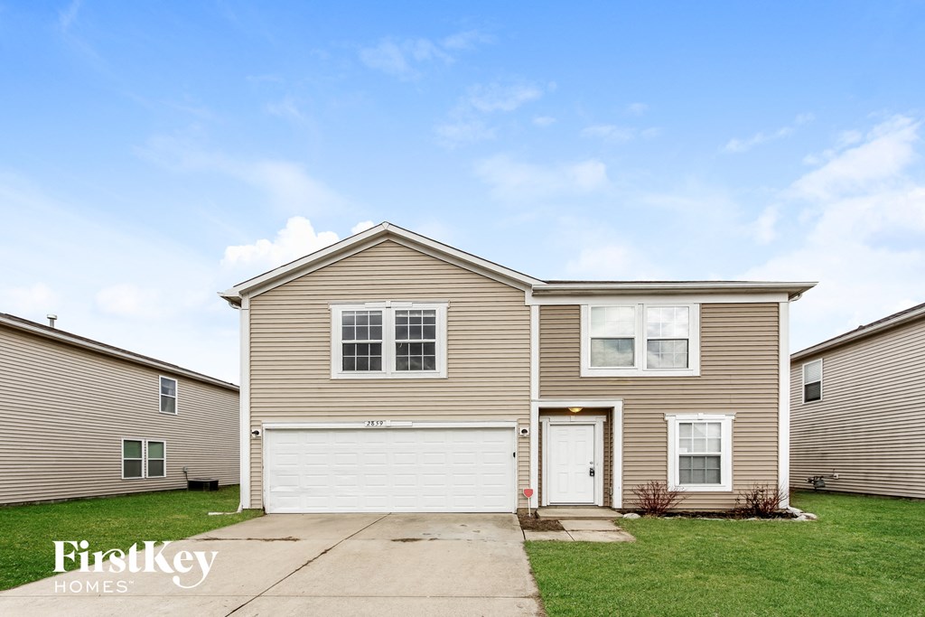 a beige house with a white garage door