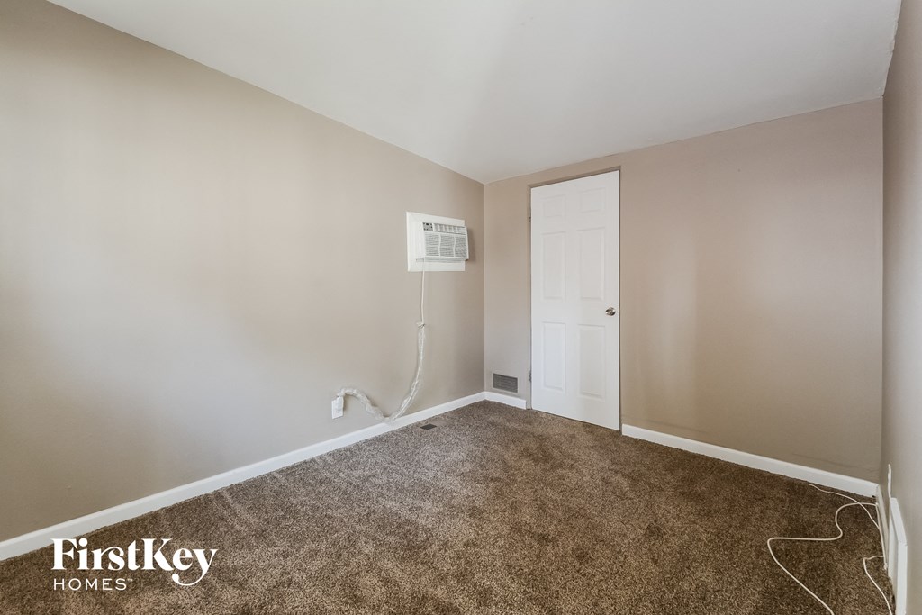 a room with a carpeted floor and a white door